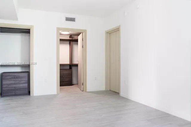 a view of an empty room with a cabinet