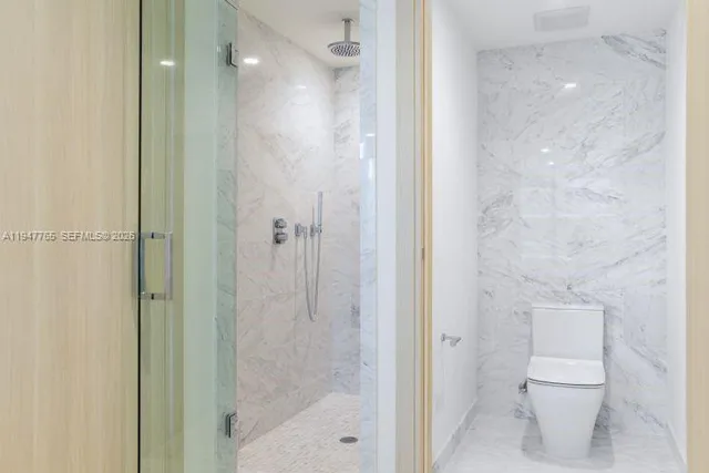 a bathroom with a shower and a toilet