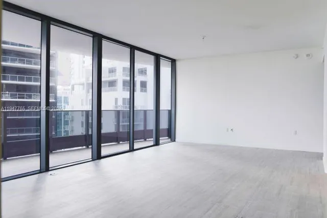 a view of an empty room with glass door