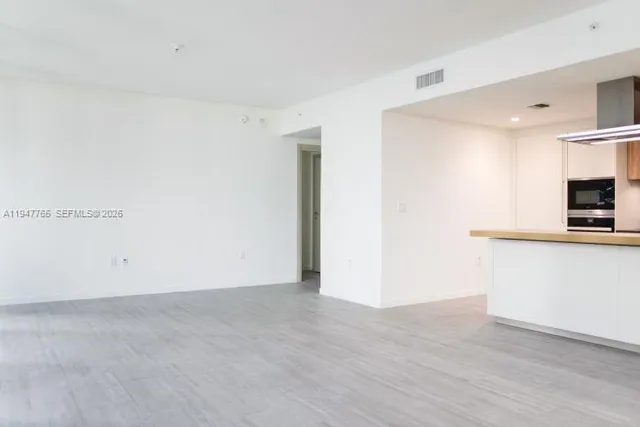 a view of storage and utility room with wooden floor