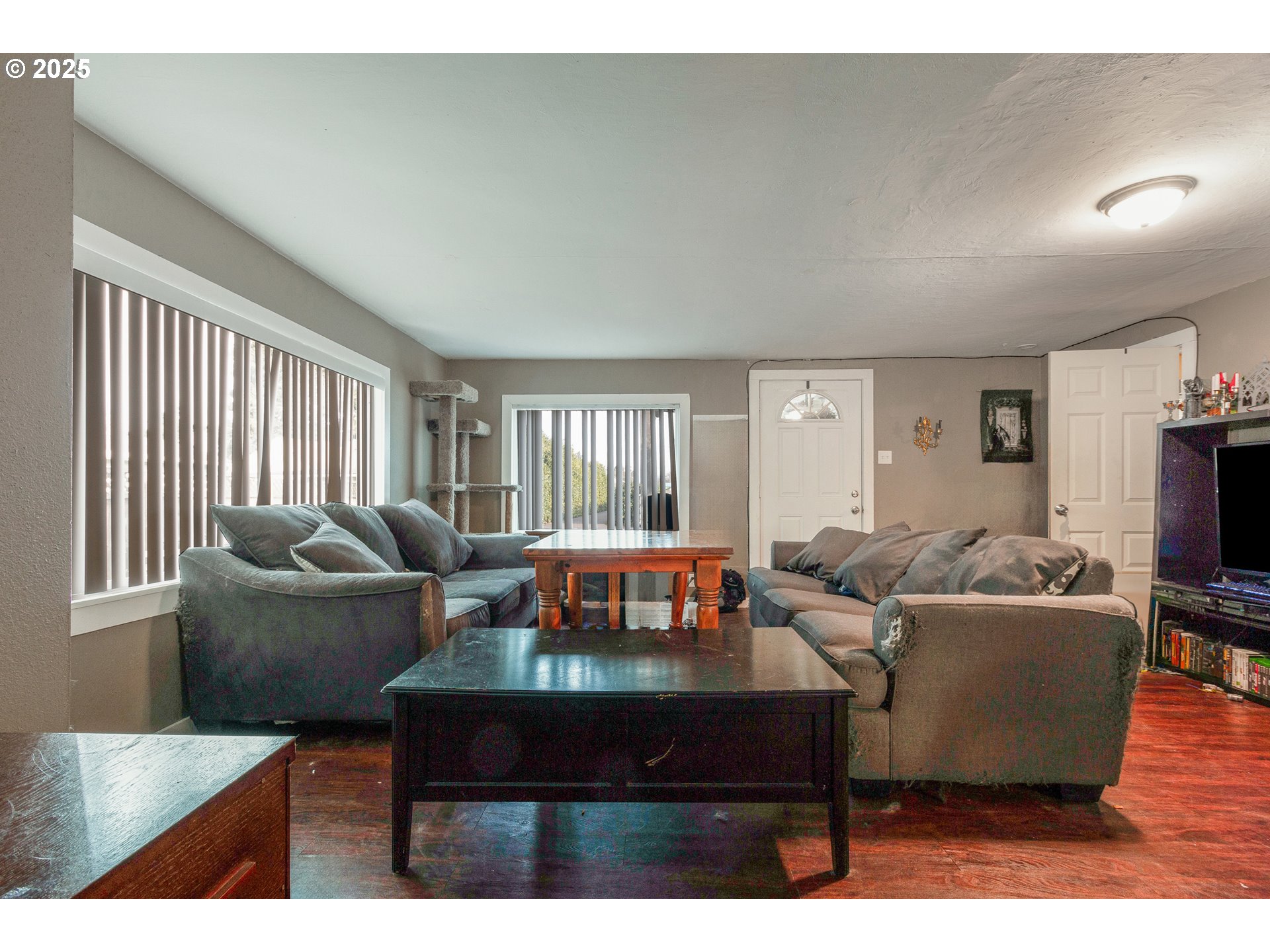 412 South 35th Street Springfield, OR 97478 - Photo 5 of 38 a living room with furniture a flat screen tv and a large window