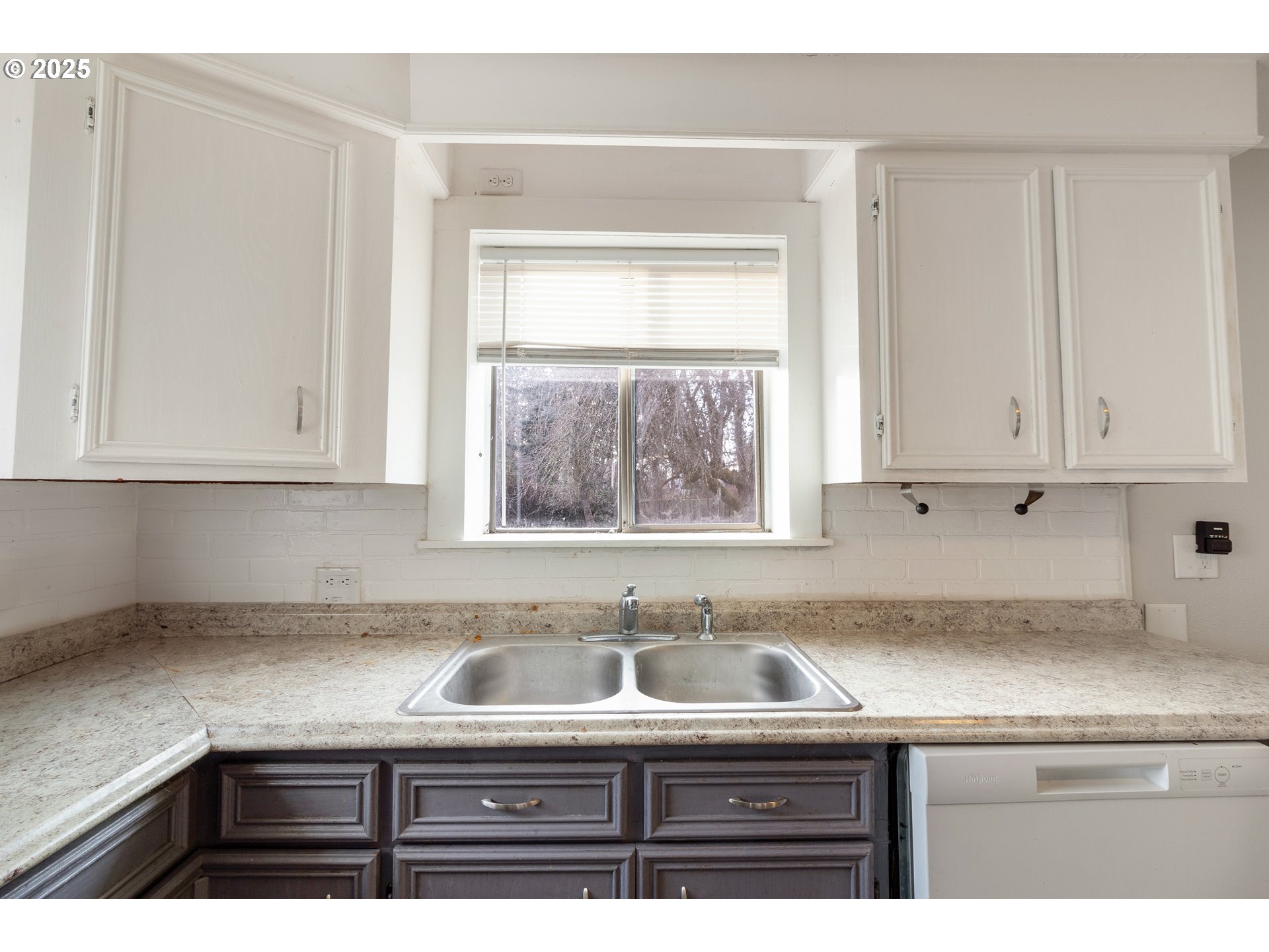 412 South 35th Street Springfield, OR 97478 - Photo 9 of 38 a kitchen with granite countertop a sink white cabinets and a window