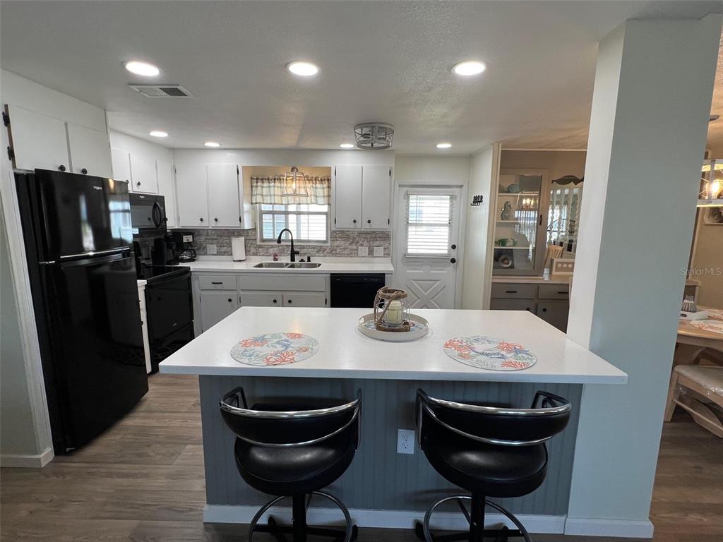 825 Coconut Palm Largo, FL 33778 - Photo 14 of 30 a large kitchen with a table and chairs