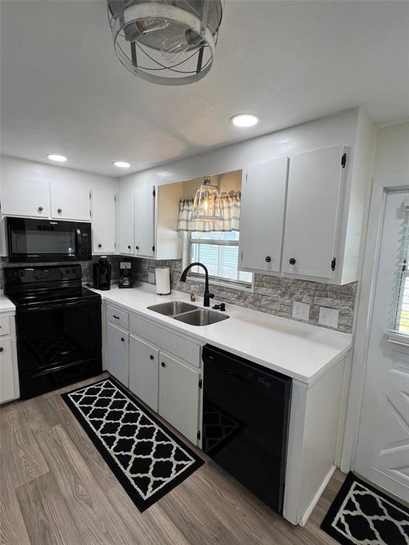 825 Coconut Palm Largo, FL 33778 - Photo 16 of 30 a kitchen with a sink stove and cabinets