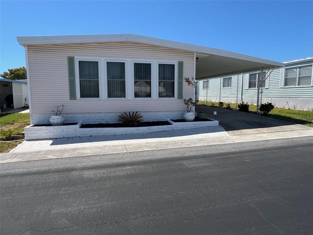 825 Coconut Palm Largo, FL 33778 - Photo 2 of 30 a front view of a house with a garden