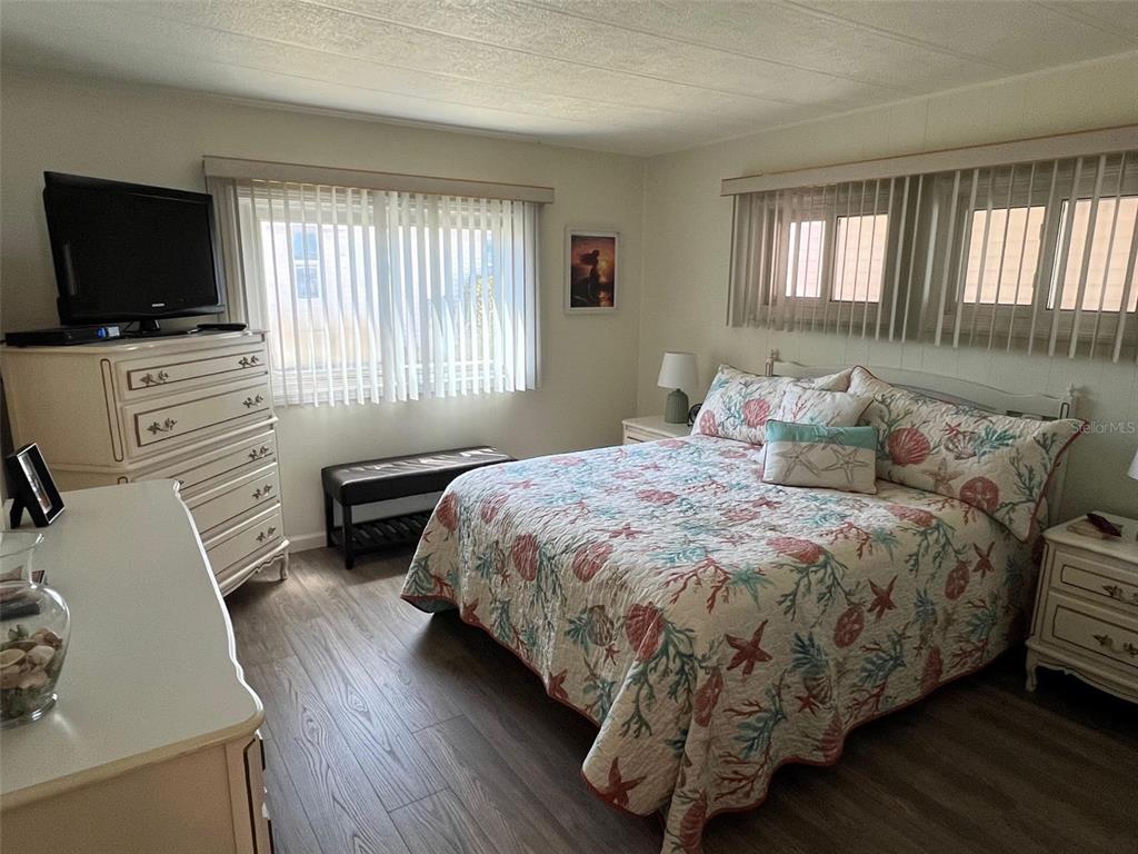 825 Coconut Palm Largo, FL 33778 - Photo 23 of 30 a bedroom with a bed and a flat screen tv