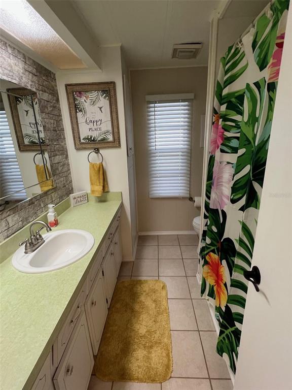 825 Coconut Palm Largo, FL 33778 - Photo 27 of 30 a spacious bathroom with mirror and tiles