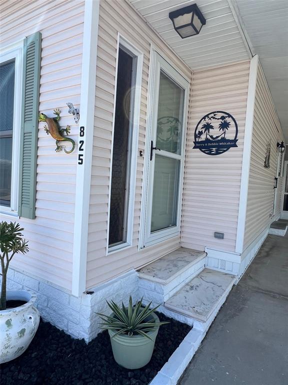 825 Coconut Palm Largo, FL 33778 - Photo 3 of 30 a front view of a house with entryway