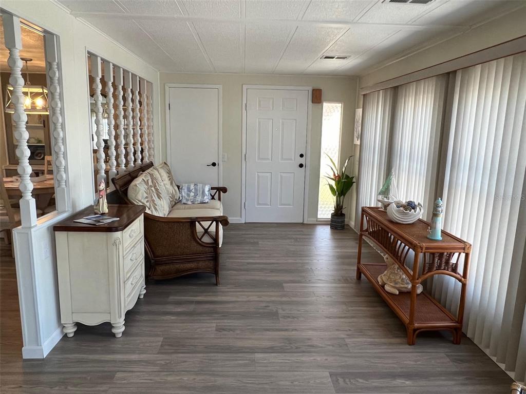 825 Coconut Palm Largo, FL 33778 - Photo 8 of 30 a view of an entryway with wooden floor and windows