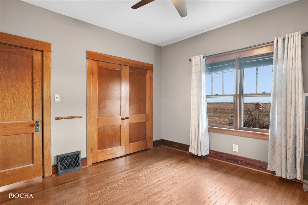 8725 Plattville Road Newark, IL 60541 - Photo 15 of 34 an empty room with wooden floor and windows