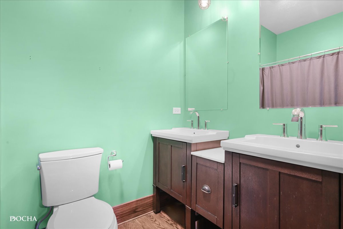 8725 Plattville Road Newark, IL 60541 - Photo 17 of 34 a bathroom with a toilet a sink and mirror