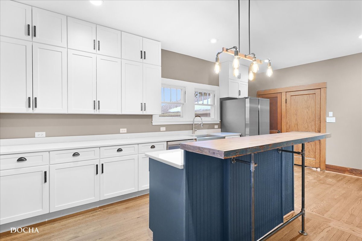 8725 Plattville Road Newark, IL 60541 - Photo 8 of 34 a kitchen with cabinets and white appliances