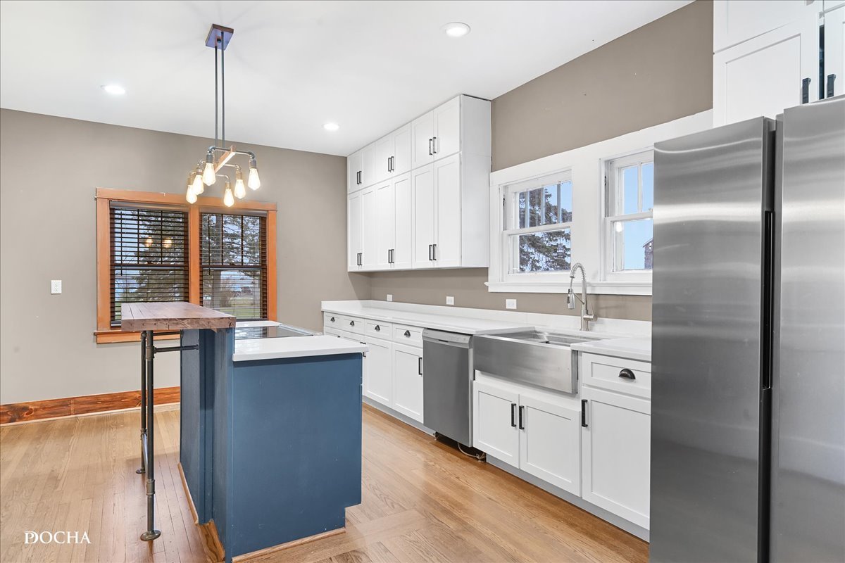 8725 Plattville Road Newark, IL 60541 - Photo 9 of 34 a kitchen with kitchen island granite countertop a sink cabinets and stainless steel appliances