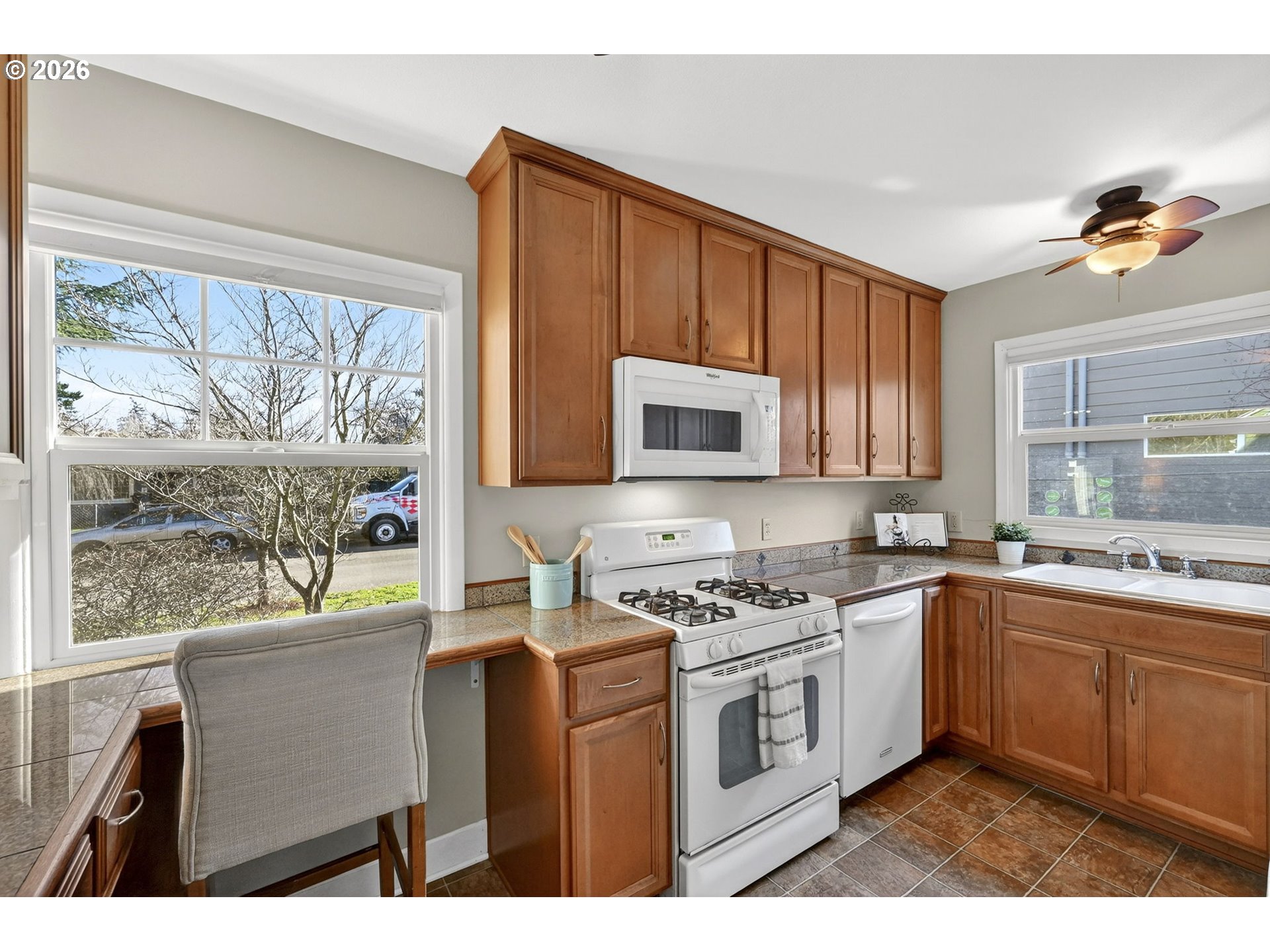 5617 Southeast 60th Avenue Portland, OR 97206 - Photo 11 of 34 a kitchen with a sink stove top oven and cabinets