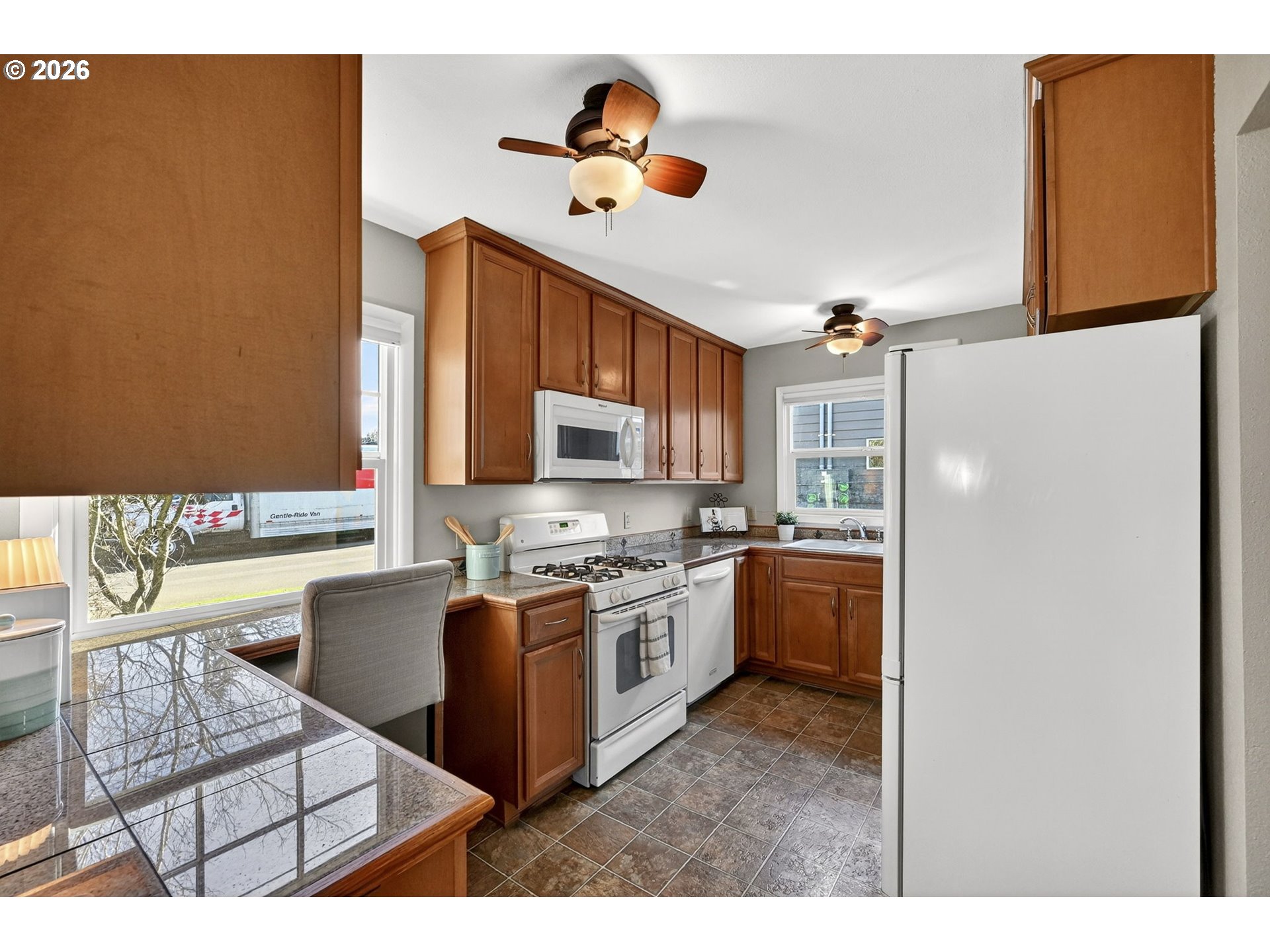 5617 Southeast 60th Avenue Portland, OR 97206 - Photo 12 of 34 a kitchen with stainless steel appliances granite countertop a stove a sink and a refrigerator
