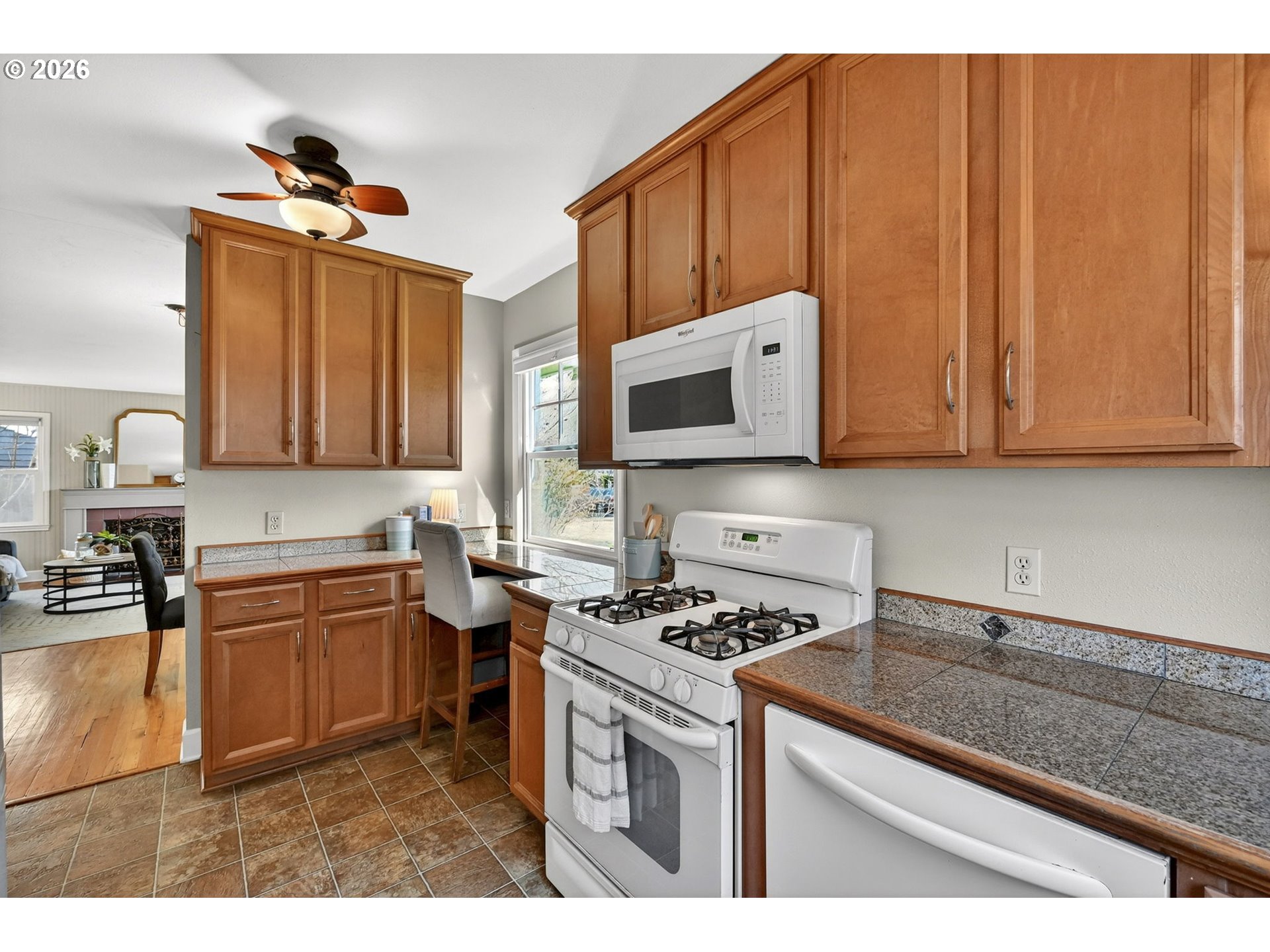 5617 Southeast 60th Avenue Portland, OR 97206 - Photo 13 of 34 a kitchen with stainless steel appliances granite countertop a sink stove and microwave