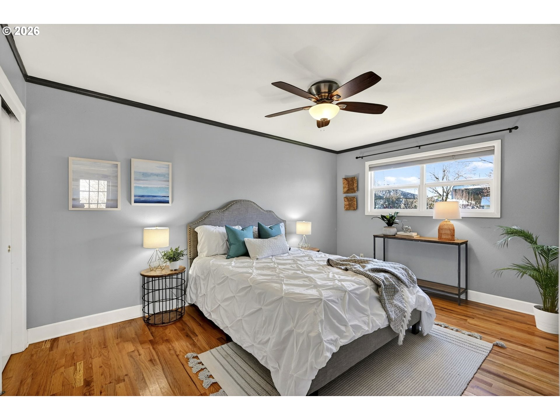 5617 Southeast 60th Avenue Portland, OR 97206 - Photo 14 of 34 a bedroom with a bed and a chandelier