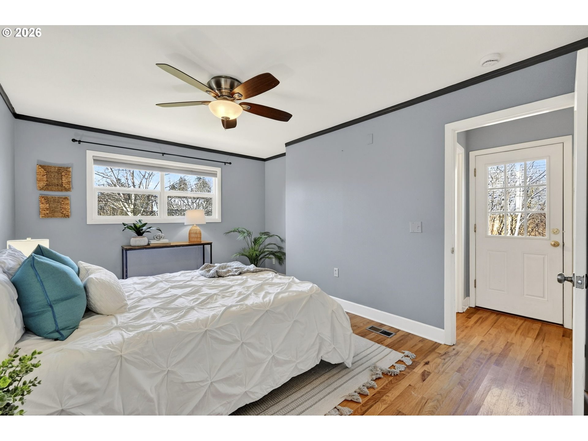 5617 Southeast 60th Avenue Portland, OR 97206 - Photo 15 of 34 a bedroom with a large bed and wooden floor