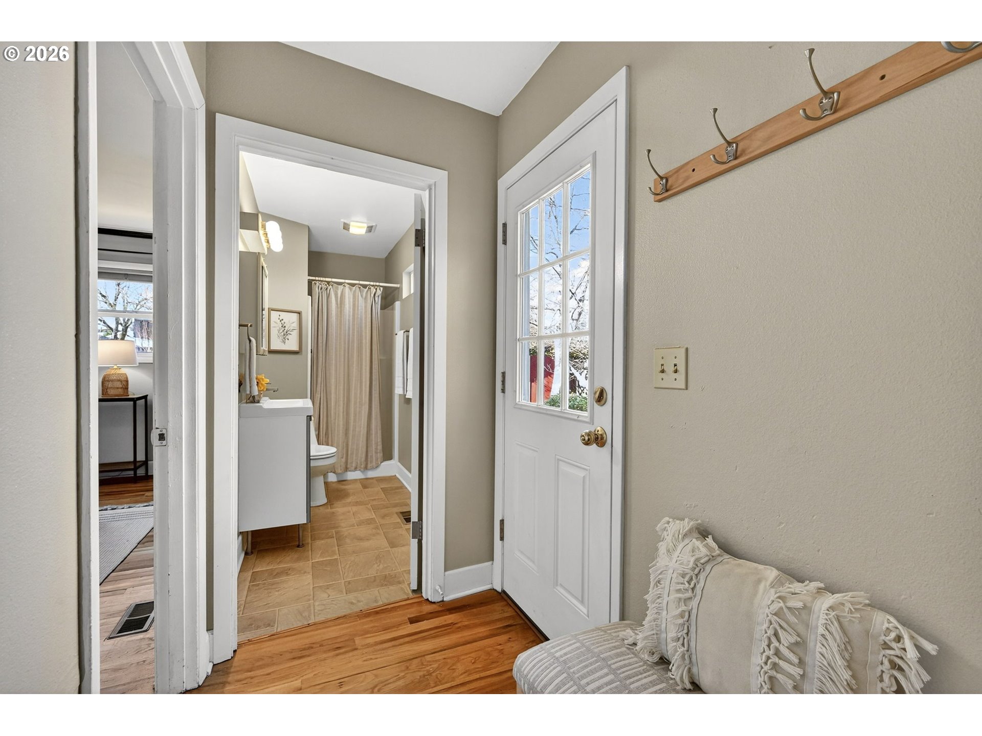 5617 Southeast 60th Avenue Portland, OR 97206 - Photo 16 of 34 a view of a hallway with wooden floor and windows