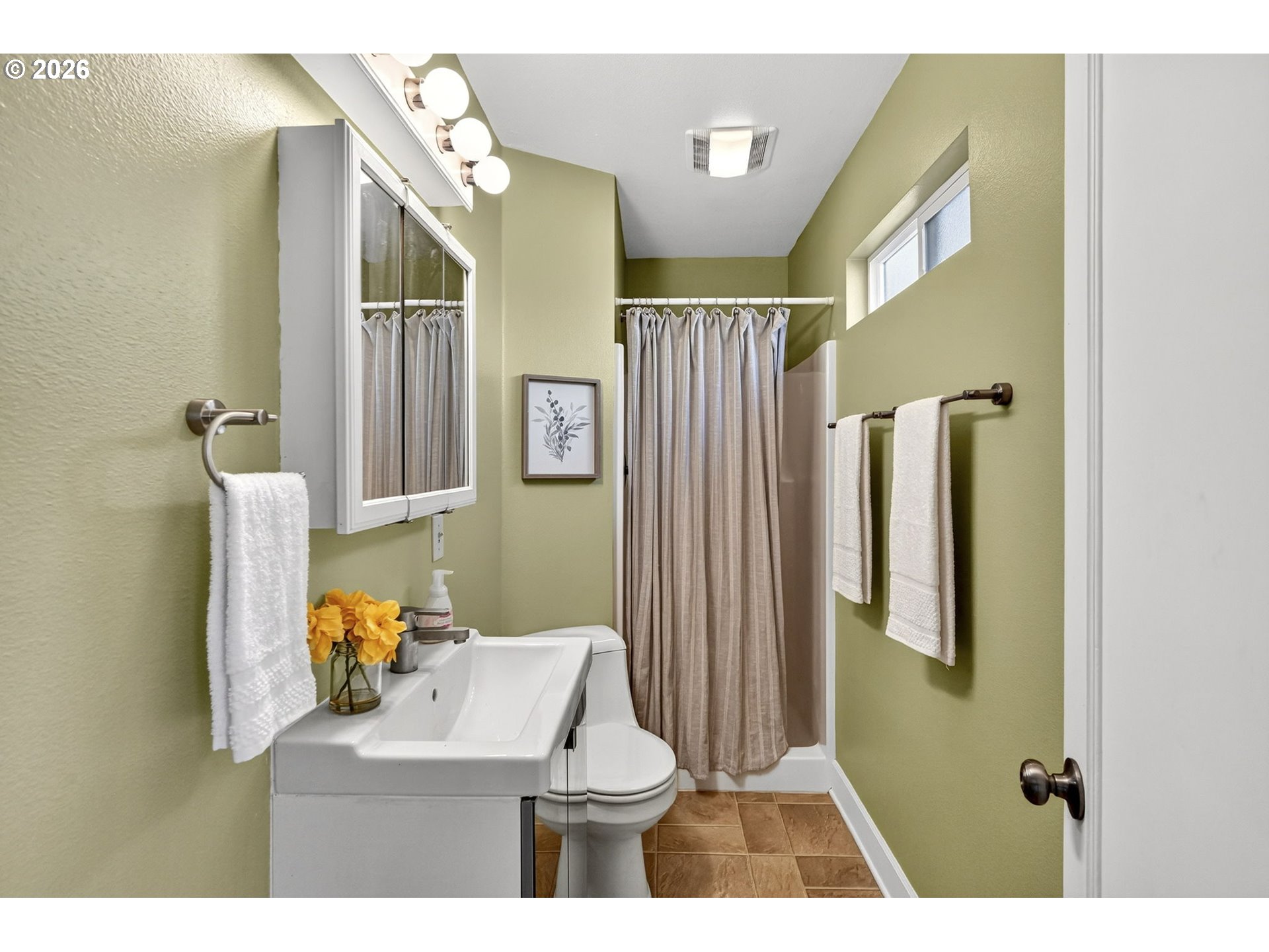 5617 Southeast 60th Avenue Portland, OR 97206 - Photo 17 of 34 a bathroom with a sink toilet and shower