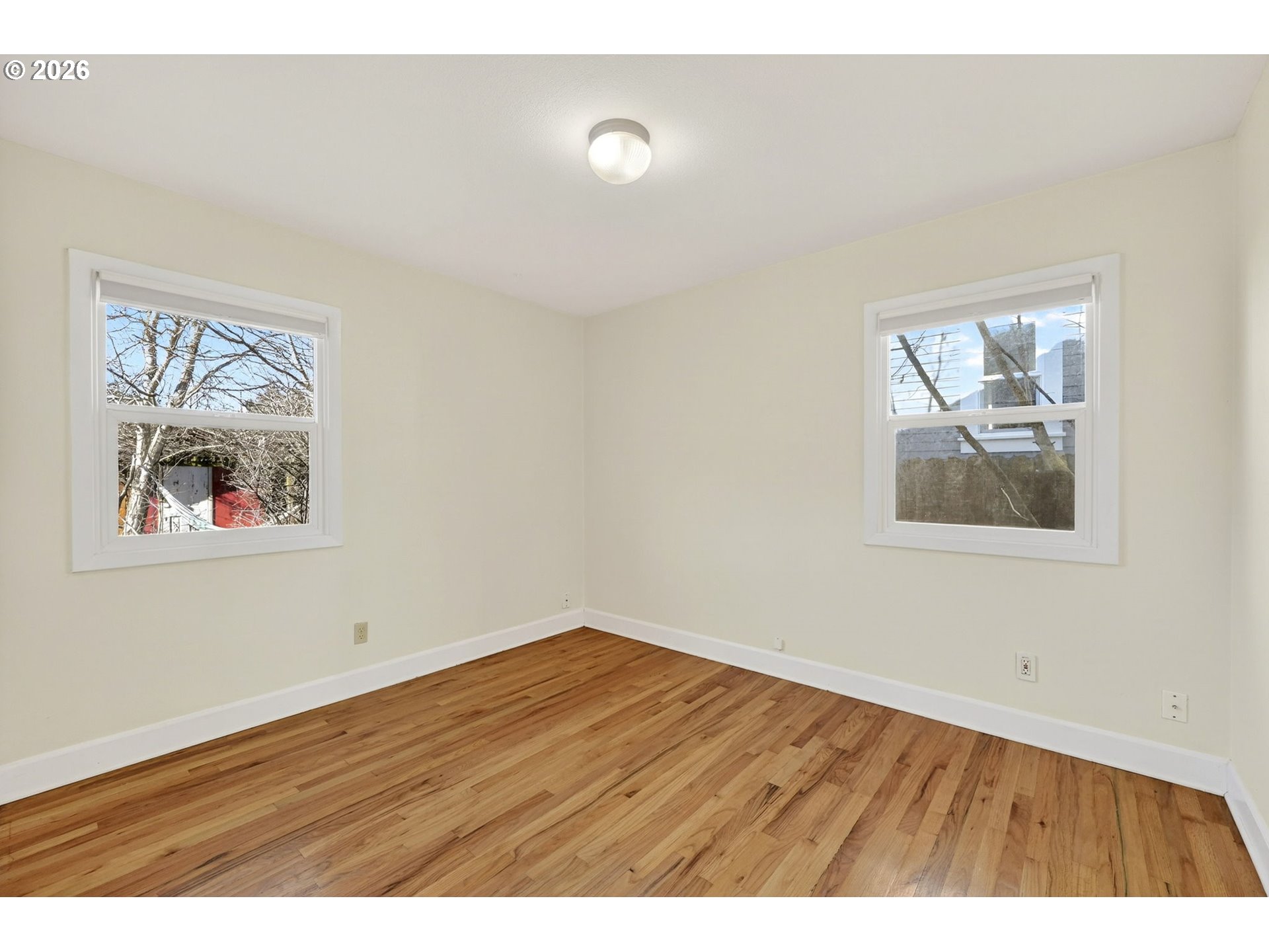 5617 Southeast 60th Avenue Portland, OR 97206 - Photo 19 of 34 a view of an empty room with wooden floor and window