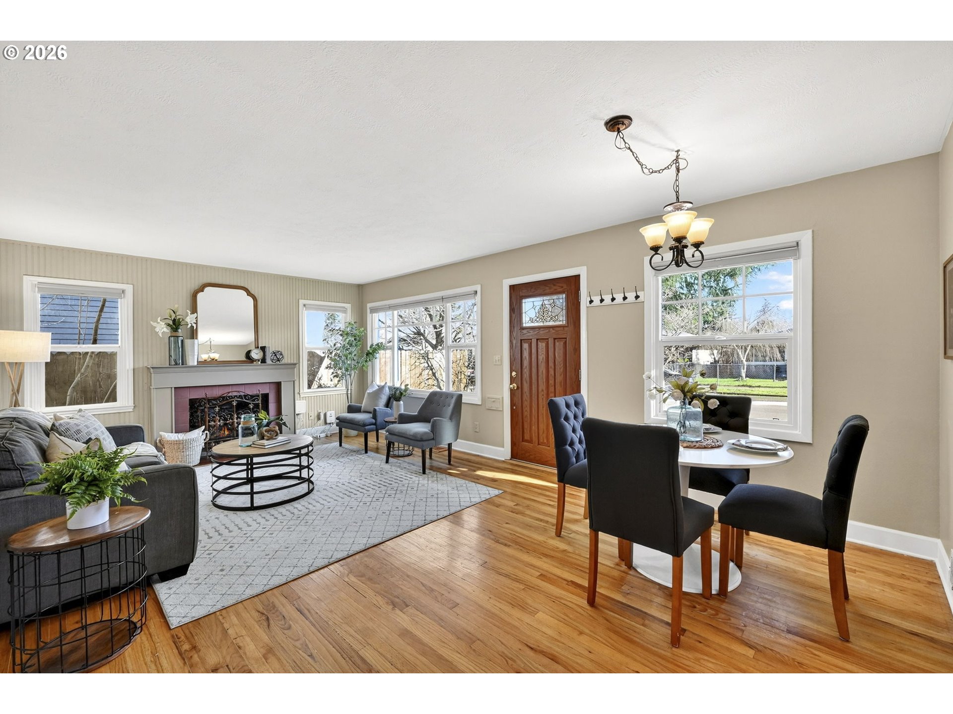 5617 Southeast 60th Avenue Portland, OR 97206 - Photo 8 of 34 a living room with furniture and a chandelier
