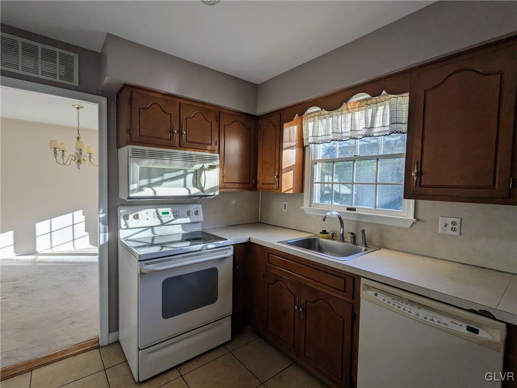 4422 Ammon Way Whitehall, PA 18052 - Photo 14 of 30 a kitchen with stainless steel appliances a stove sink and cabinets