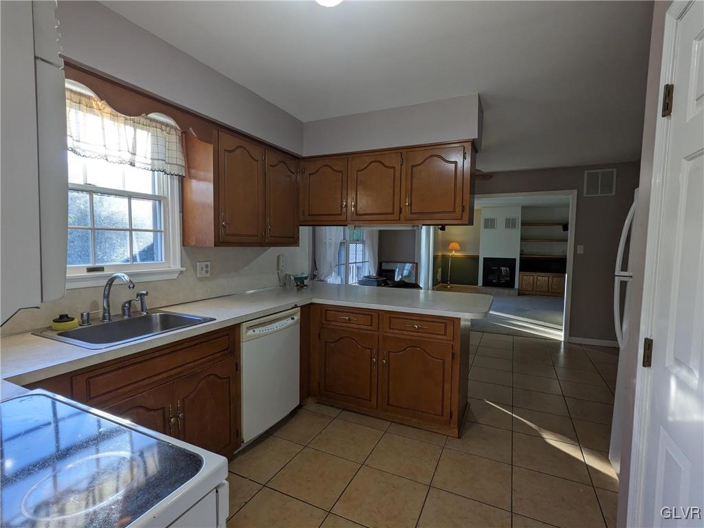 4422 Ammon Way Whitehall, PA 18052 - Photo 15 of 30 a kitchen with stainless steel appliances granite countertop a sink stove and refrigerator
