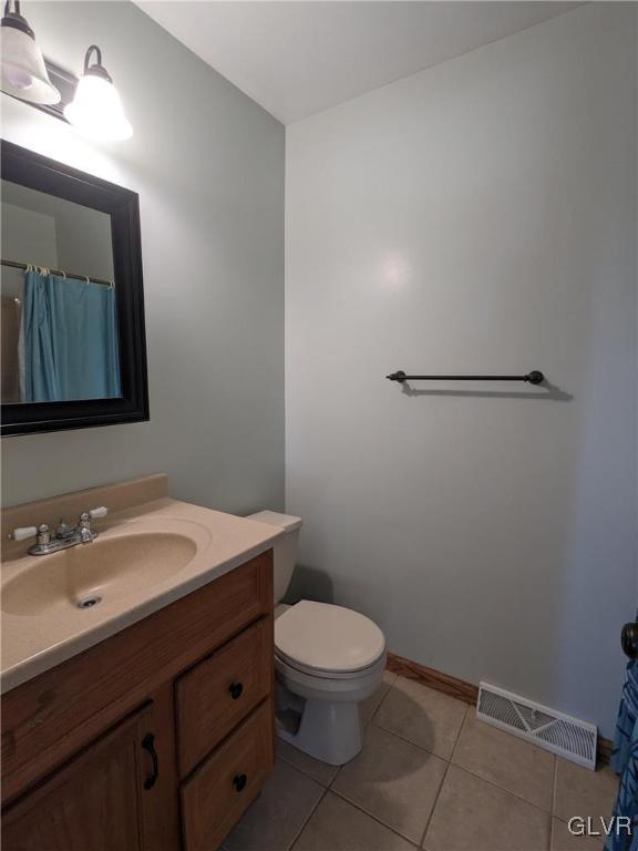 4422 Ammon Way Whitehall, PA 18052 - Photo 28 of 30 a bathroom with a toilet a sink and mirror