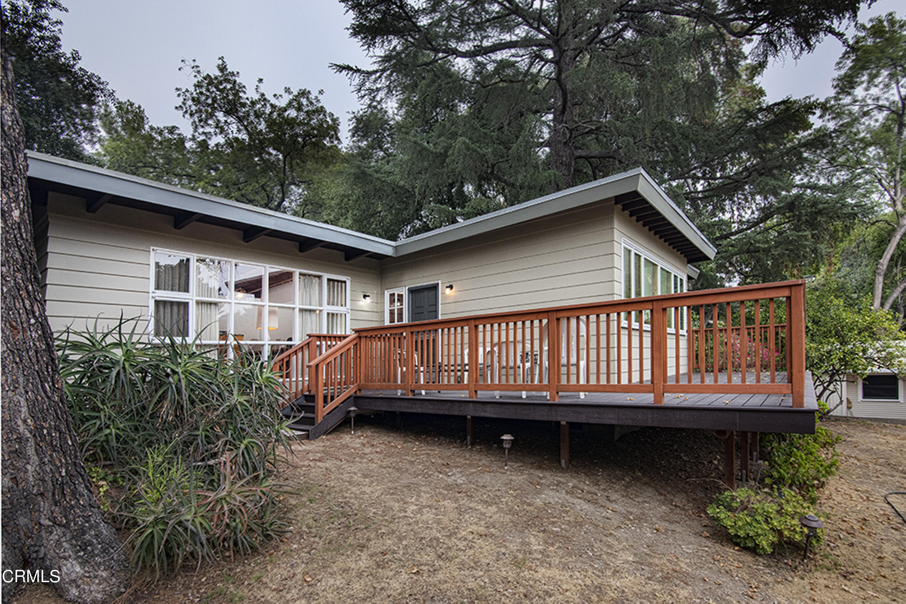 a view of backyard with deck and wooden floor