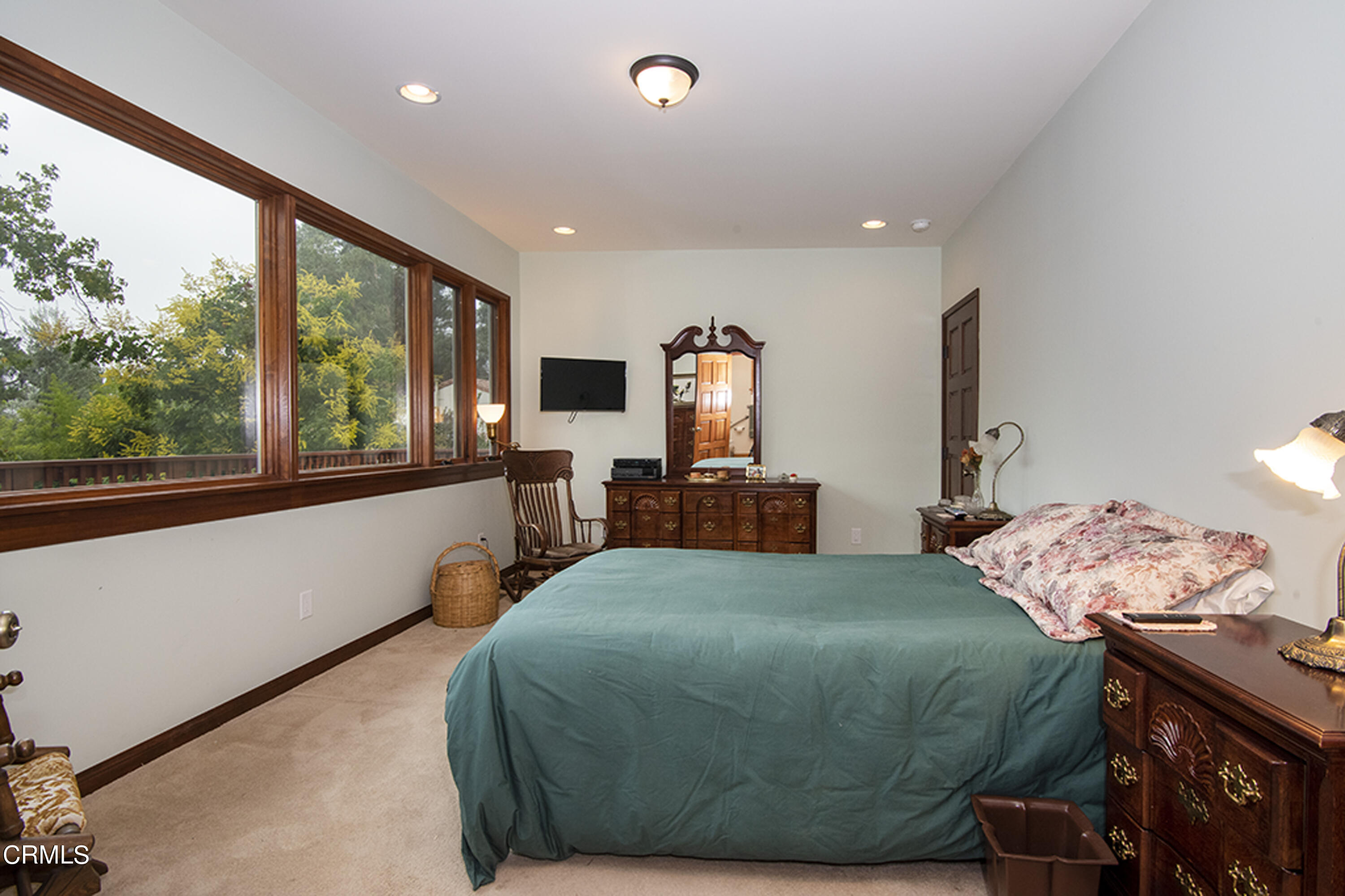 2888 Reposa Lane Altadena, CA 91001 - Photo 16 of 60 a bedroom with a bed and large windows