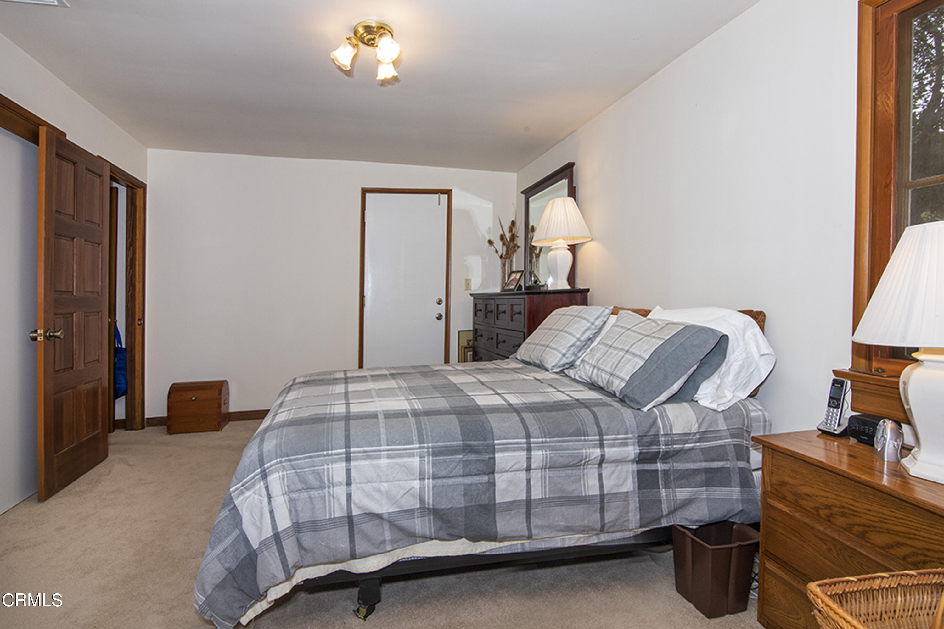 2888 Reposa Lane Altadena, CA 91001 - Photo 20 of 60 a bedroom with a bed and a chandelier