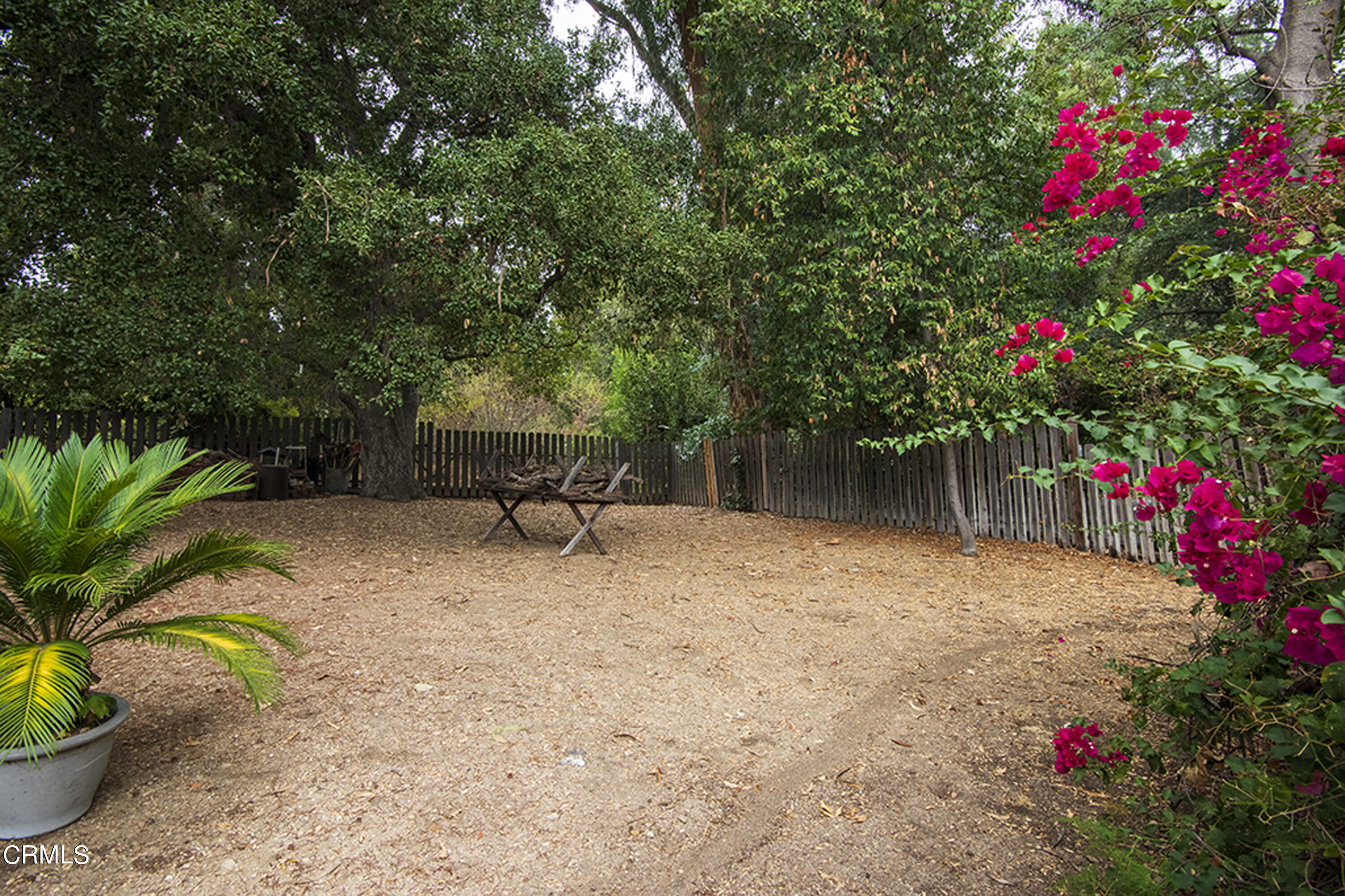 2888 Reposa Lane Altadena, CA 91001 - Photo 53 of 60 a backyard of a house with table and chairs and wooden fence