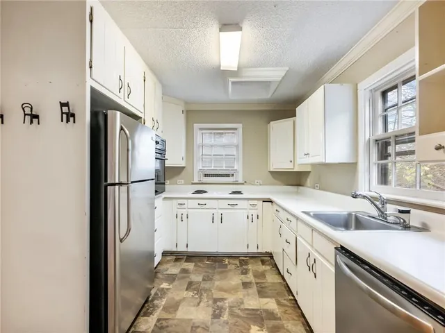 a kitchen with a sink stove and refrigerator