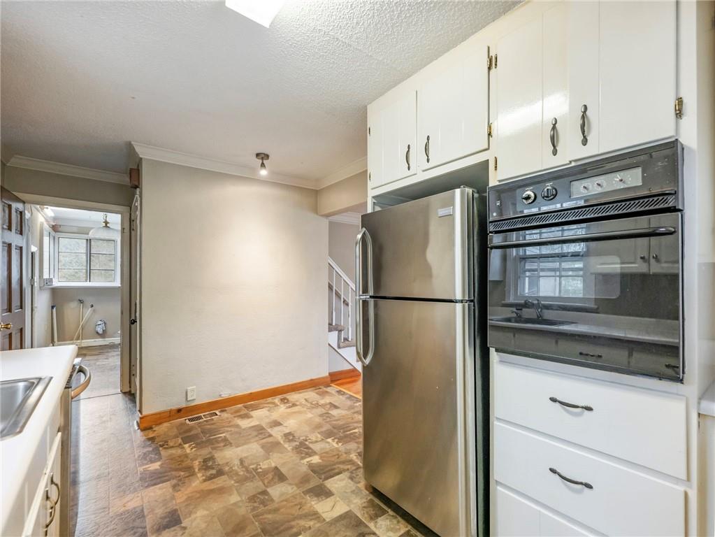 1093 Enota Avenue Northeast Gainesville, GA 30501 - Photo 12 of 47 a kitchen with a refrigerator and a stove top oven