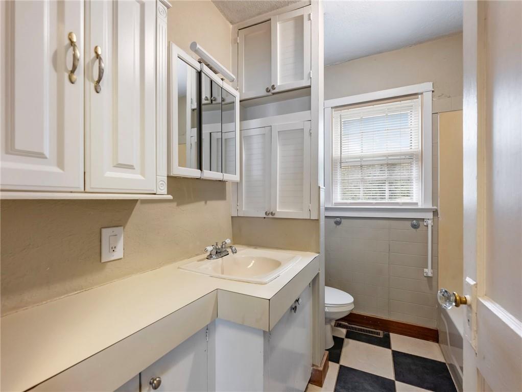 1093 Enota Avenue Northeast Gainesville, GA 30501 - Photo 21 of 47 a bathroom with a sink and a mirror