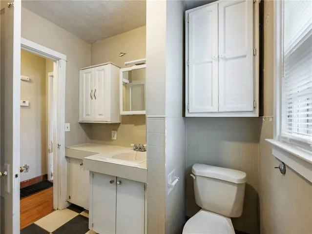 an empty room with a window and ceiling fan