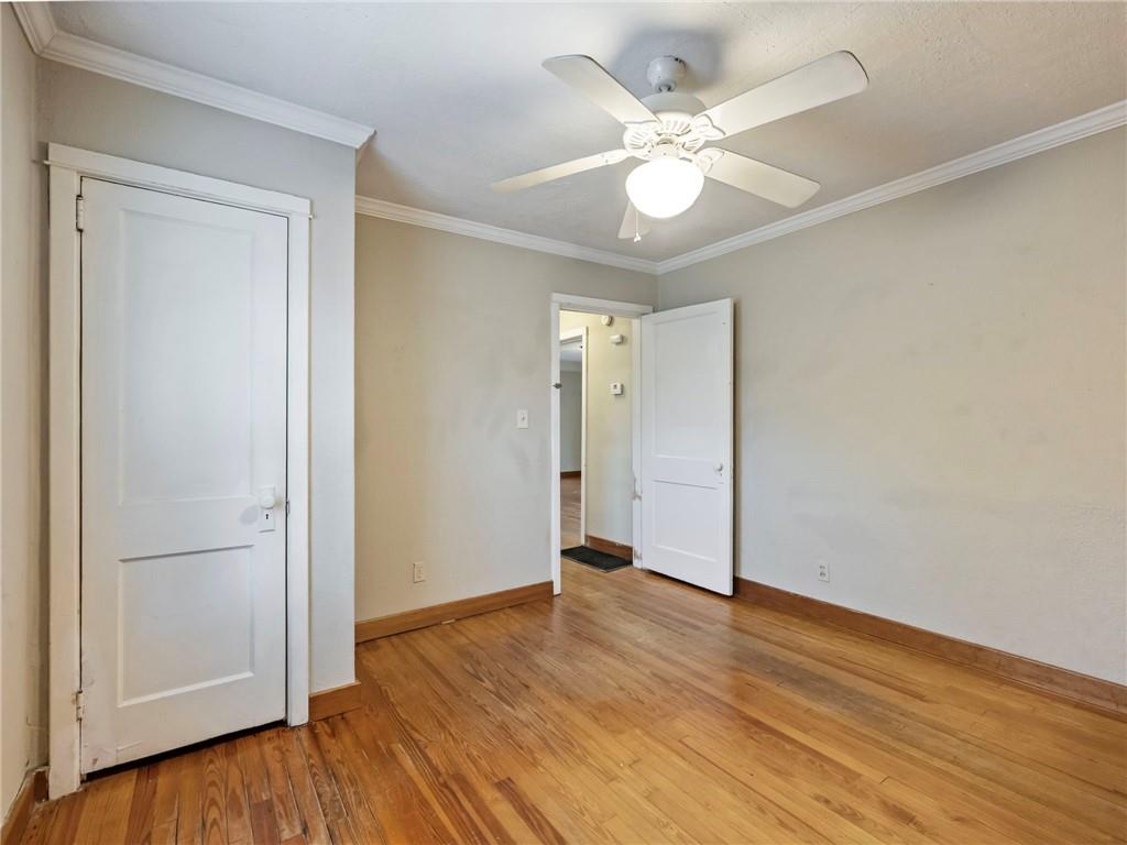1093 Enota Avenue Northeast Gainesville, GA 30501 - Photo 25 of 47 an empty room with wooden floor and ceiling fan