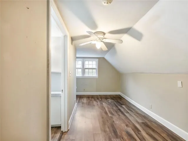 a view of a livingroom with wooden floor and a ceiling fan