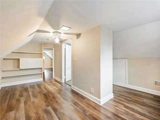 a view of a room with wooden floor