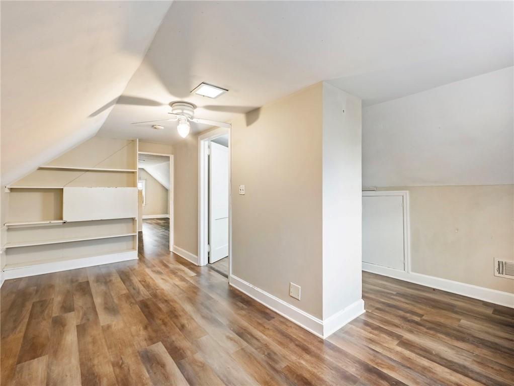 1093 Enota Avenue Northeast Gainesville, GA 30501 - Photo 31 of 47 a view of a livingroom with wooden floor and a ceiling fan