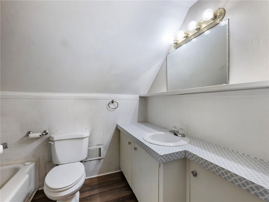 1093 Enota Avenue Northeast Gainesville, GA 30501 - Photo 33 of 47 a bathroom with a sink a toilet and vanity