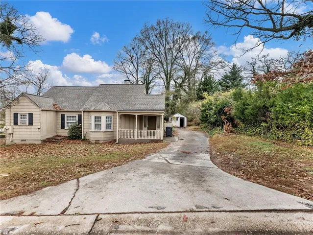 a view of a house with a yard covered in snow