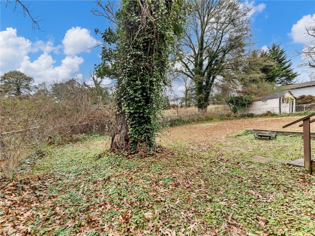 1093 Enota Avenue Northeast Gainesville, GA 30501 - Photo 42 of 47 a view of a yard with large trees
