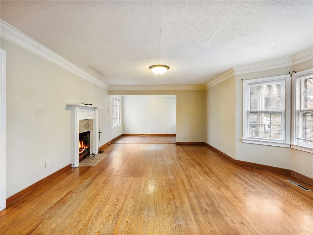1093 Enota Avenue Northeast Gainesville, GA 30501 - Photo 6 of 47 an empty room with wooden floor and windows