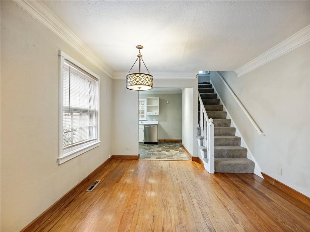 1093 Enota Avenue Northeast Gainesville, GA 30501 - Photo 8 of 47 a view of staircase with wooden floor and white walls