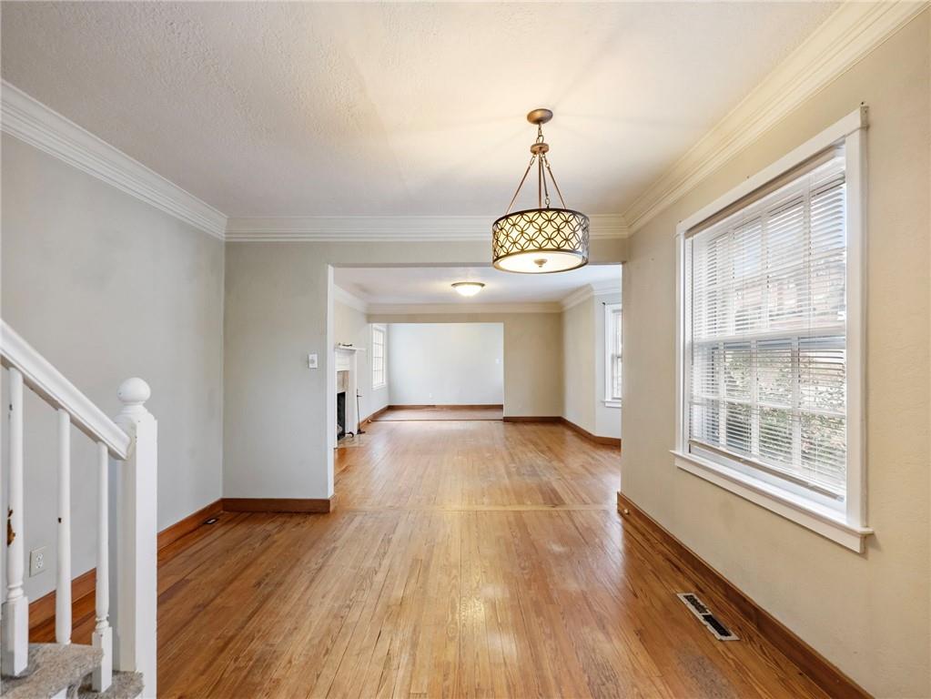 1093 Enota Avenue Northeast Gainesville, GA 30501 - Photo 9 of 47 a view of an empty room with window and wooden floor