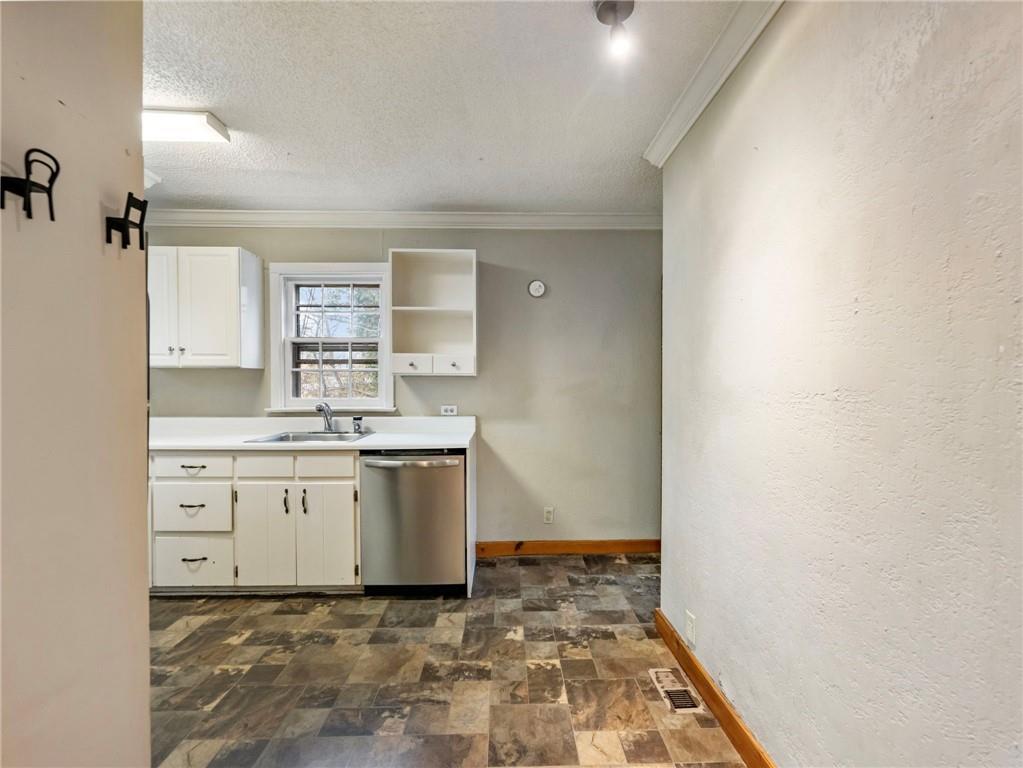 1093 Enota Avenue Northeast Gainesville, GA 30501 - Photo 10 of 47 a room with a stove a sink and a window
