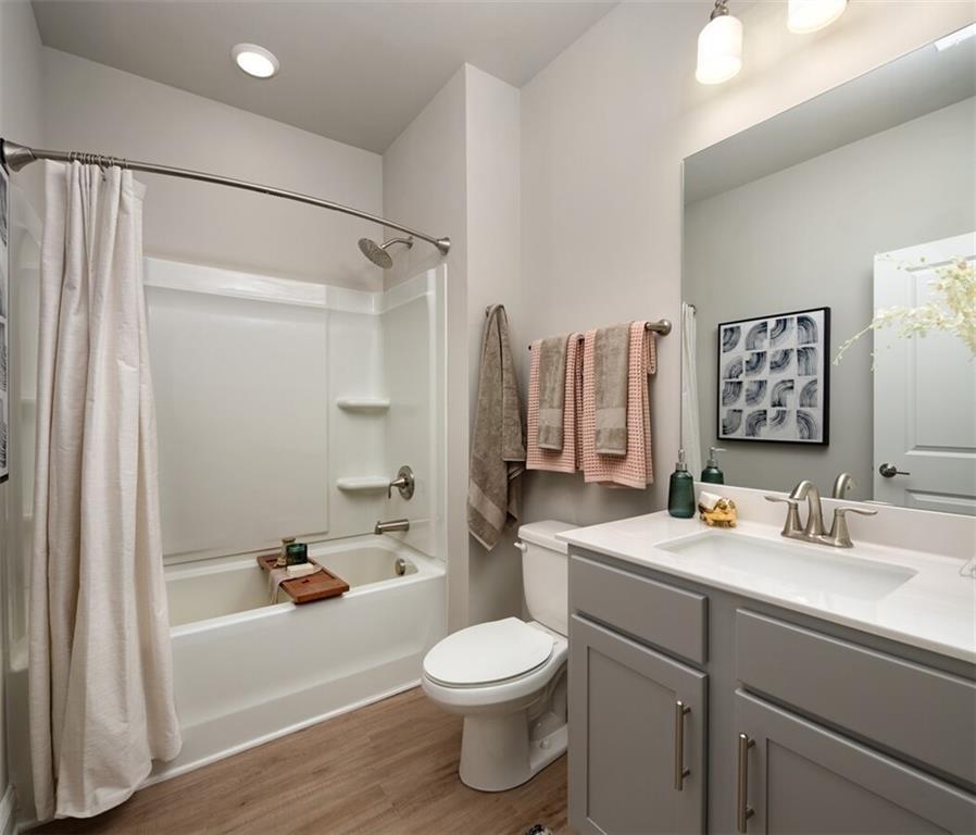 3960 Redan Road, Unit B2 Stone Mountain, GA 30083 - Photo 6 of 23 a bathroom with a sink a toilet and a large mirror