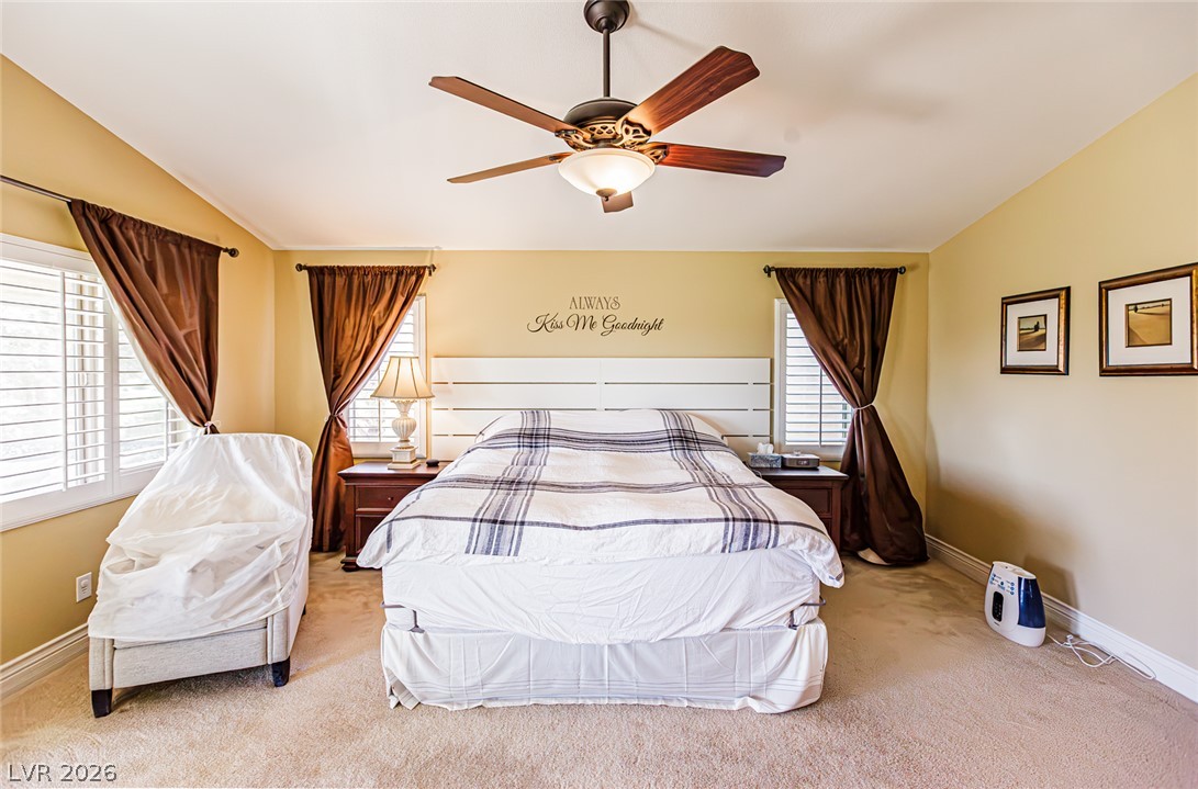75 Tall Ruff Drive Las Vegas, NV 89148 - Photo 36 of 64 Warm natural light fills this bedroom featuring wall-to-wall carpeting and symmetrical shuttered windows.